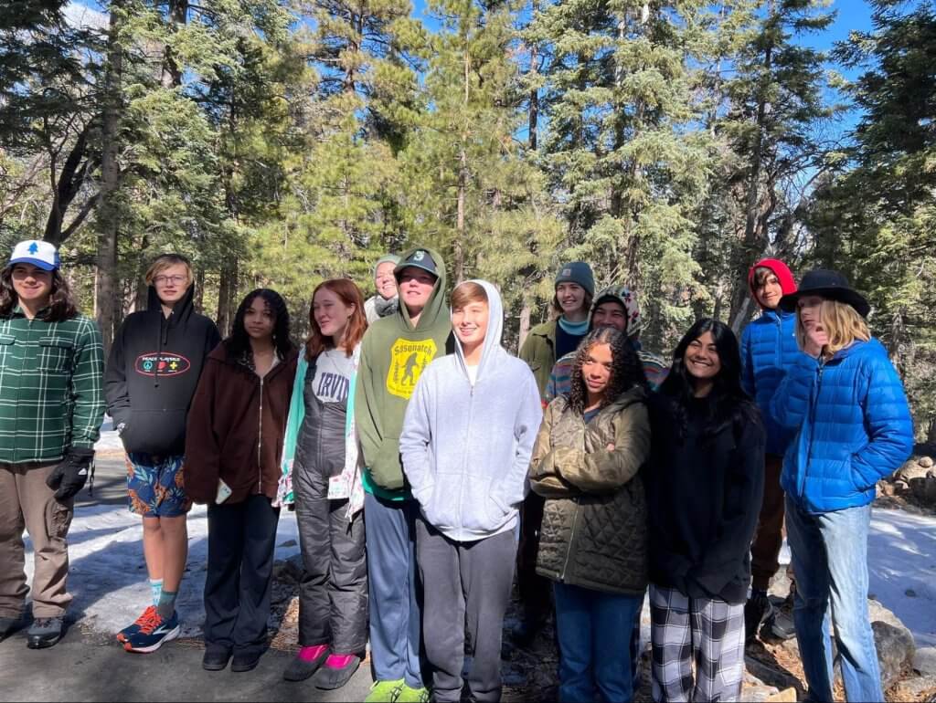 Group of youth stand at snowy Camp de Benneville