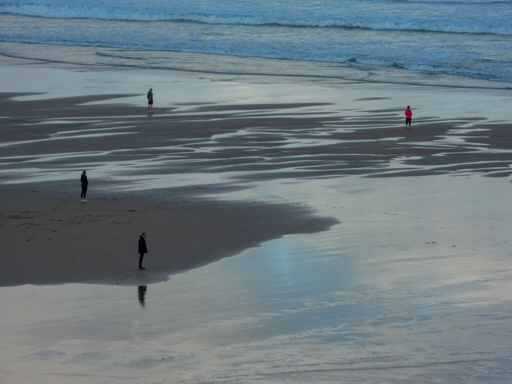 individuals on the beach at low tide - photo