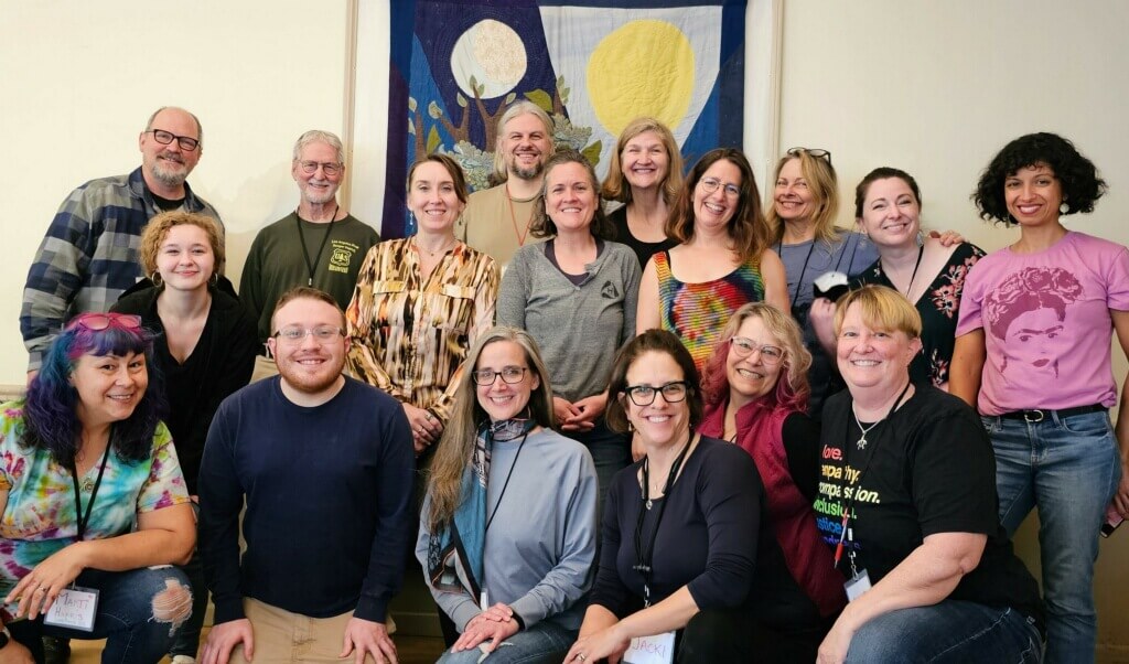 Group of smiling adults gathered for OWL facilitator training - photo