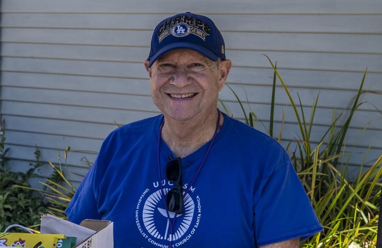 Headshot of RE volunteer Larry Weiner, smiling wearing ballcap and UUSM tee - photo