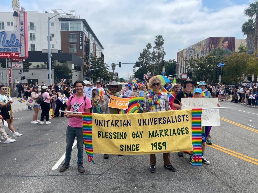 Kion and Ian carrying the UUSM banner at the 2024 LA Pride Parade