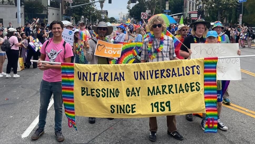 Kion and Ian carrying the UUSM banner at the 2024 LA Pride Parade