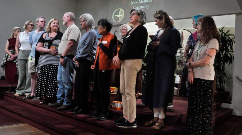 UUSM new members being introduced on the chancel