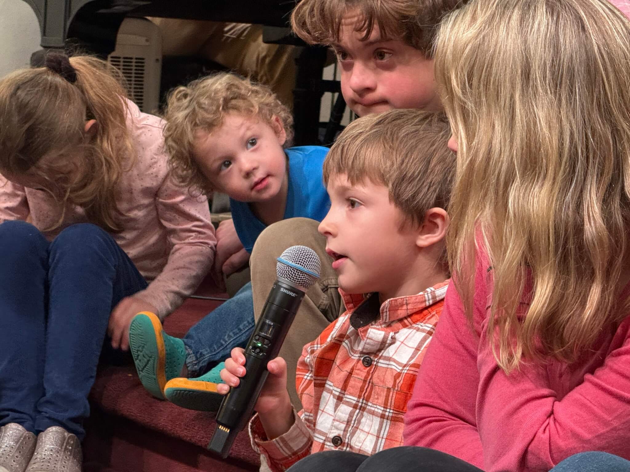 Child speaking into mic during Sunday service