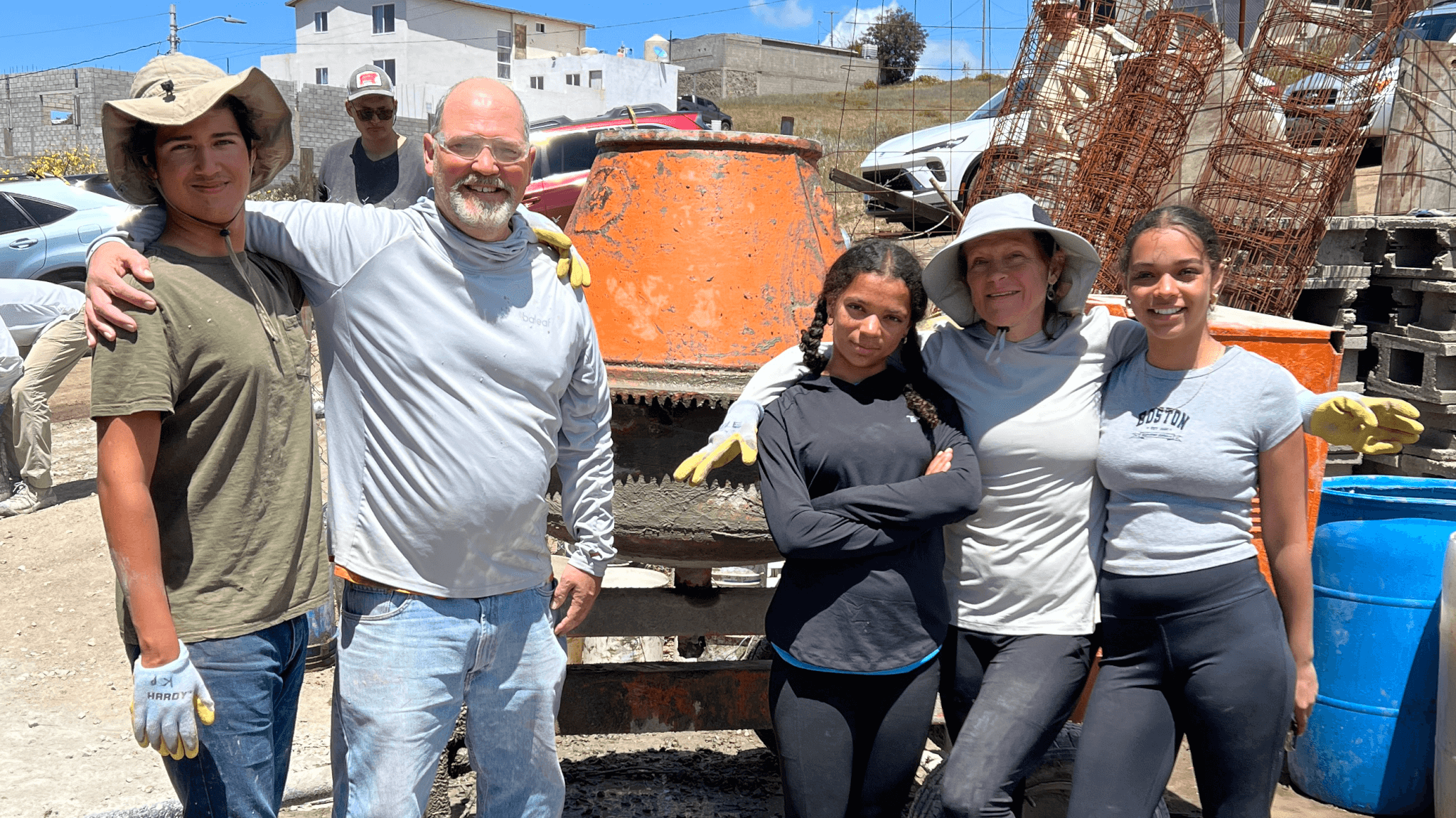 Two families in front of Cement mixer