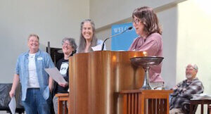 Committee members laughing with Eileen in the pulpit