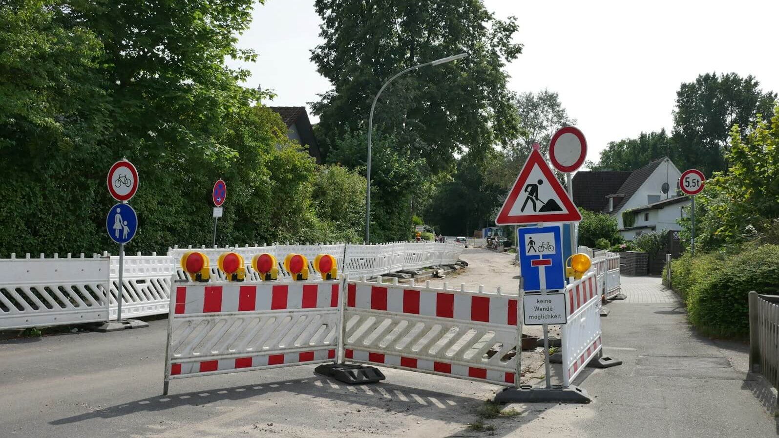 a road closed off with barricades and signs