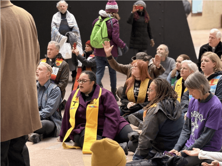 UUA President Sophia Betancourt and others sitting on floor before arrest on 1/29/2026.