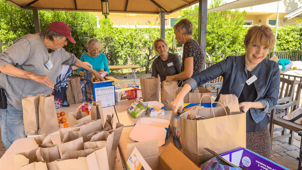 People packing lunch bags for people in need on Sunday